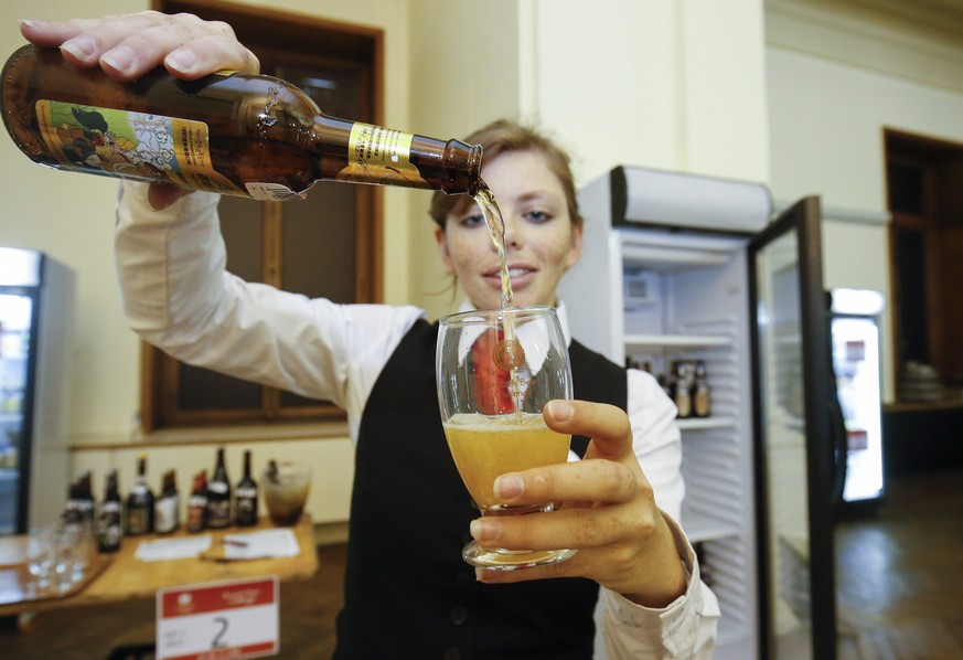 epa05653424 (FILE) The file picture dated 05 November 2016 shows a waitress serving beer during the 5th Brussels Beer Challenge in Brussels, Belgium. The UNESCO added the beer culture in Belgium among ...