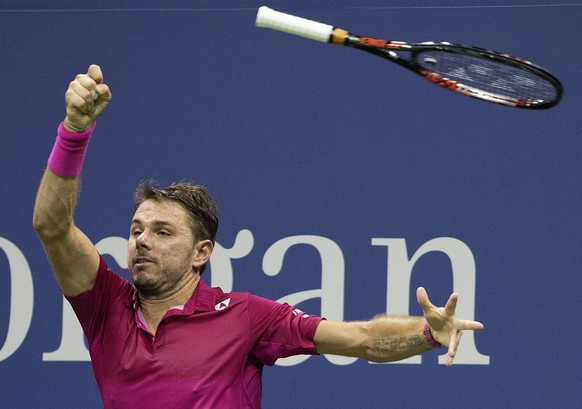 epa05532699 Stan Wawrinka of Switzerland loses his grip on his racquet as he hits a return to Kei Nishikori of Japan during their semifinal round match on the twelfth day of the US Open Tennis Champio ...