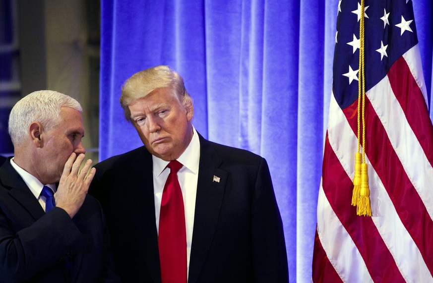 epa05711343 US President-elect Donald Trump (C) talks with Vice-President-Elect Mike Pence (L) during a press conference in the lobby of Trump Tower in New York, New York, USA, 11 January 2017. Trump, ...