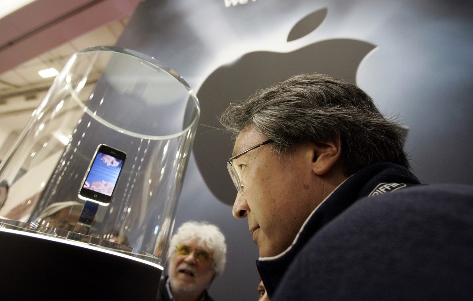 Engineer Joe Wang looks at the Apple iPhone at MacWorld Conference after the announcement of the phone in San Francisco, Wednesday, Jan. 10, 2007. Among consumers, the excitement around Apple Inc.&#03 ...