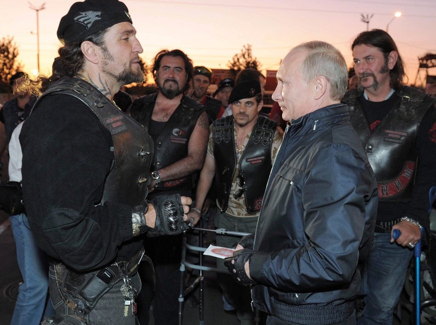 epa02887595 Russian Prime Minister Vladimir Putin (front R) speaks with the Night Wolves bikers organization leader Alexander Zaldostanov (L) during his visit to a bike festival at the Black Sea port  ...