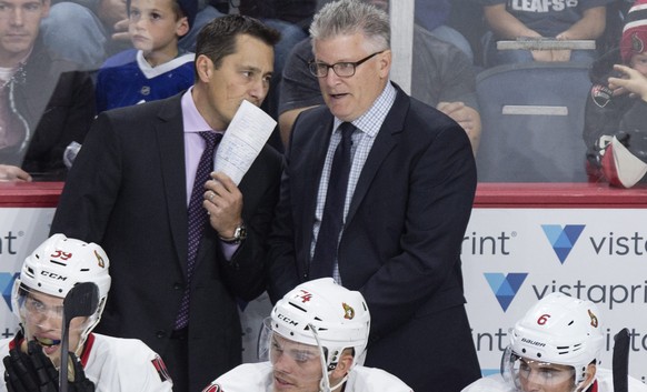 Ottawa Senators head coach Guy Boucher, left, speaks with assistant coach Marc Crawford during the third period of a preseason NHL hockey game in Halifax, Nova Scotia, Monday, Sept. 26, 2016. (Darren  ...