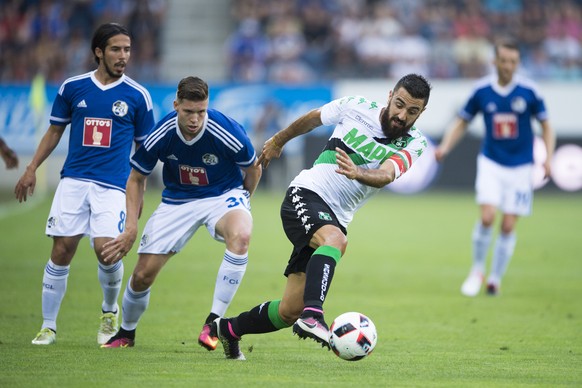 Francesco Magnanelli, centre right, of Sassuolo, and Cedric Itten, centre left, of Luzern, in action, during the UEFA Europa League third qualifying round first leg soccer match between Swiss Club FC  ...