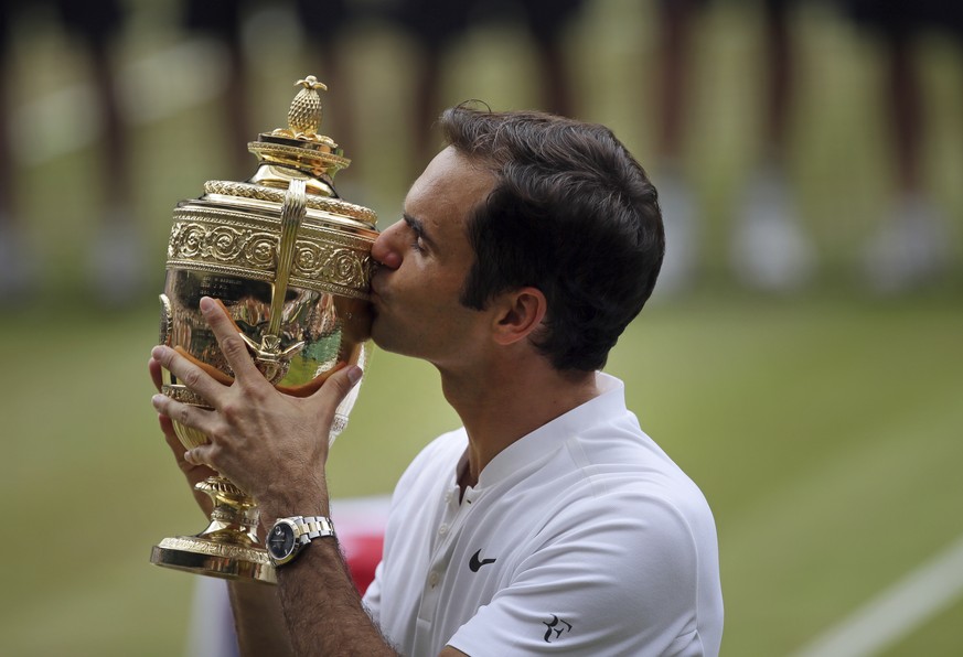 Switzerland&#039;s Roger Federer celebrates with the trophy after beating Croatia&#039;s Marin Cilic in the Men&#039;s Singles final match on day thirteen at the Wimbledon Tennis Championships in Lond ...