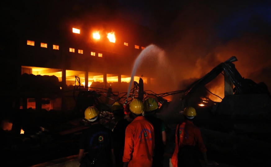 Firefighters work to put out a fire at a packaging factory in Tongi industrial area outside Dhaka, Bangladesh, Saturday, Sept. 10, 2016. A boiler exploded and triggered a fire at a packaging factory n ...