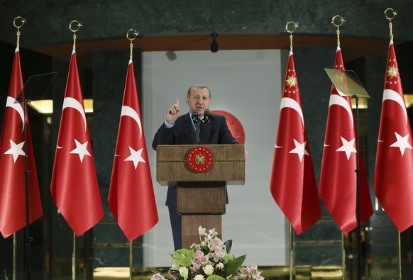 Turkey&#039;s President Recep Tayyip Erdogan, gestures as he delivers a speech at a dinner to break the Ramadan fast in Ankara, Turkey, Thursday, June 15, 2017. Erdogan has slammed the U.S. decision t ...