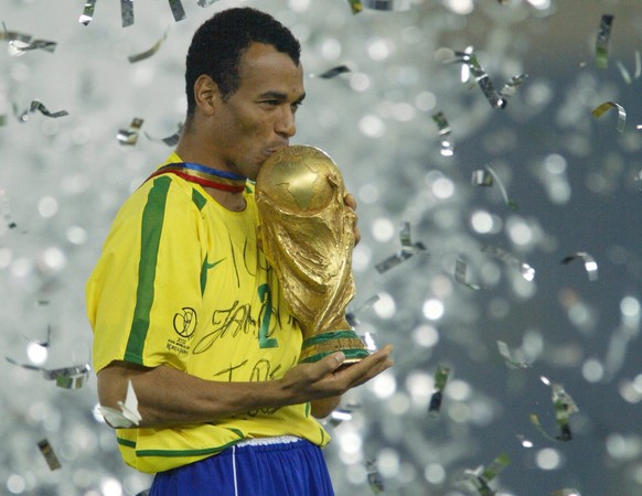 Brazil&#039;s team captain and defender Cafu kisses the World Cup trophy, celebrating Brazil&#039;s 2-0 victory over Germany in the 2002 FIFA World Cup Korea Japan final, Sunday 30 June 2002 at the In ...