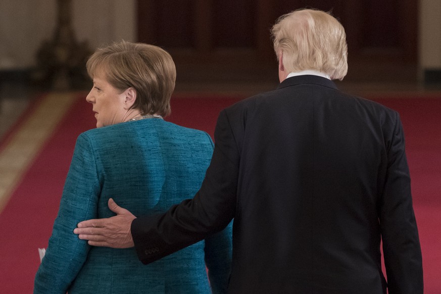 epa05854859 US President Donald J. Trump (R) and Chancellor of Germany Angela Merkel (L) leave the East Room following a joint press conference in the East Room of the White House in Washington, DC, U ...