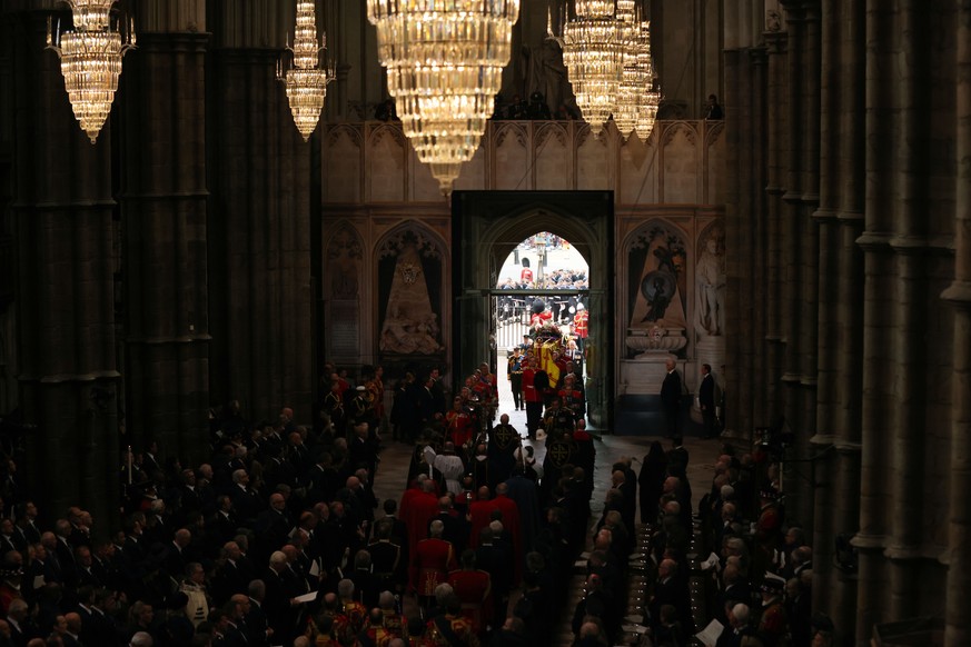 The coffin of Queen Elizabeth II is carried into Westminster Abbey ahead of her State Funeral, in London, Monday Sept. 19, 2022. The Queen, who died aged 96 on Sept. 8, will be buried at Windsor along ...