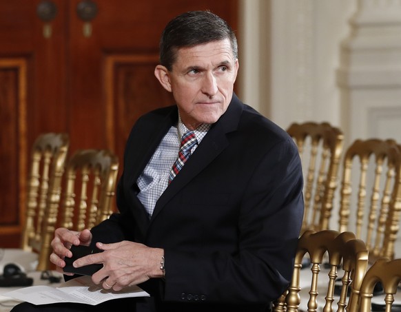 FILE - In this Feb. 10, 2017 file photo, then-National Security Adviser Michael Flynn sits in the East Room of the White House in Washington. President Barack Obama warned Donald Trump against hiring  ...