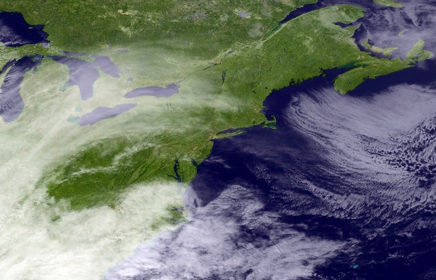 This satellite image taken around 3:11 p.m. EDT and released by the National Oceanic and Atmospheric Administration, shows clouds around the Northeast of the United States, Monday, March 13, 2017. A p ...