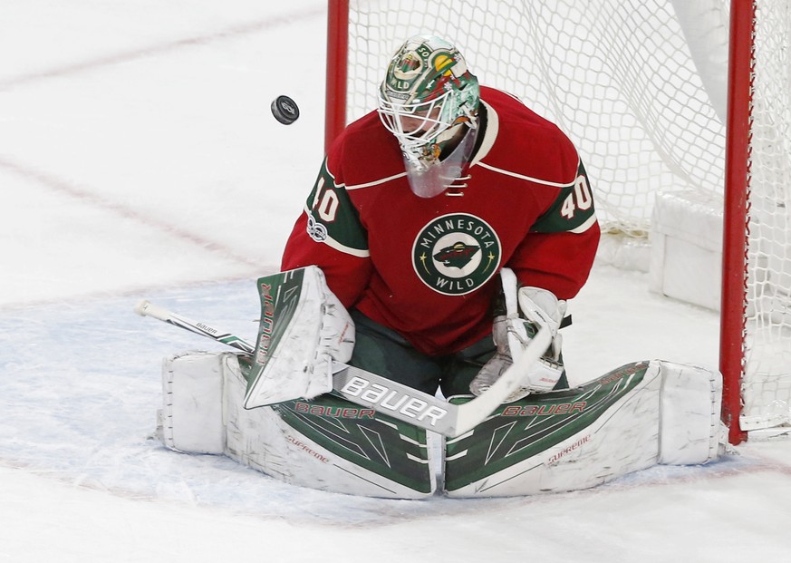 Minnesota Wild goalie Devan Dubnyk deflects a shot during the first period of an NHL hockey game against the St. Louis Blues, Tuesday, March 7, 2017, in St. Paul, Minn. (AP Photo/Jim Mone)