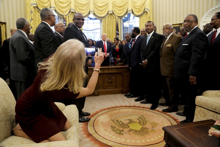 epa05819709 Counselor to the President Kellyanne Conway takes a picture of US President Donald J. Trump with members of the Historically Black Colleges and Universities in the Oval Office of the White ...