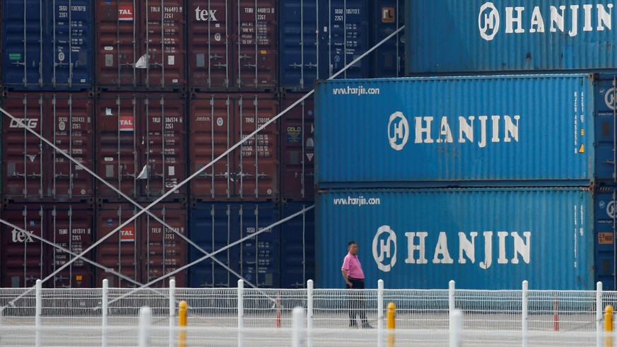 A man stands in front of shipping containers at the Hanjin Shipping container terminal at Incheon New Port in Incheon, South Korea, September 7, 2016. REUTERS/Kim Hong-Ji