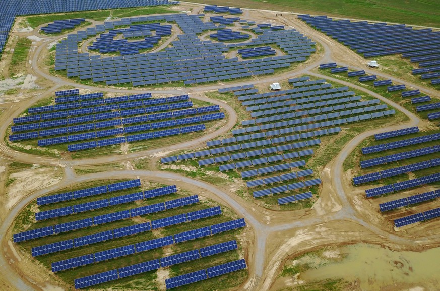 epa06108534 An aerial view taken by a drone shows the Datong Panda Power Plant where solar panels are placed to form the pattern of pandas in Datong, Shanxi Province of China, 25 July 2017. The world& ...