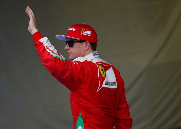 Formula One - Japanese Grand Prix - Suzuka Circuit, Japan - 8/10/16. Ferrari&#039;s Kimi Raikkonen of Finland waves his hand after the qualifying session. REUTERS/Toru Hanai