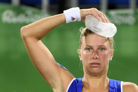 Andrea Hlavackova from Czech Republic keeps ice on his head after being hit by a tennis ball of Swiss Martina Hingis during the women&#039;s semi-final doubles match Timea Bacsinszky and Martina Hingi ...