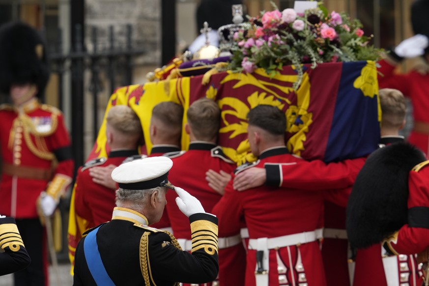 King Charles III salutes as the coffin of his mother Queen Elizabeth II is carried into Westminster Abbey for her funeral in central London, Monday, Sept. 19, 2022. The Queen, who died aged 96 on Sept ...