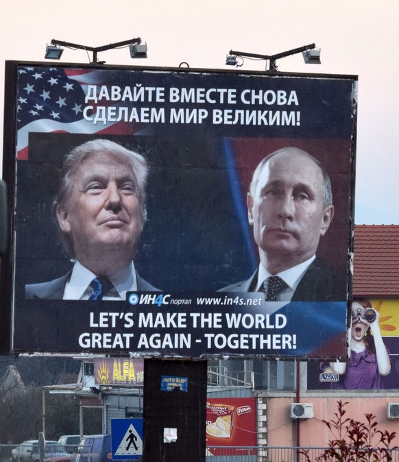 epaselect epa05634154 A billboard by pro-Serbian movement shows the image US President-elect Donald Trump and Russian President Vladimir Putin as a truck drives past in the town of Danilovgrad, Monten ...