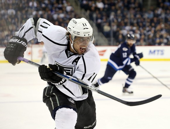Oct 27, 2015; Winnipeg, Manitoba, CAN; Los Angeles Kings center Anze Kopitar (11) chases a loose puck during the third period against the Winnipeg Jets at MTS Centre. Los Angeles Kings win 4-1. Mandat ...