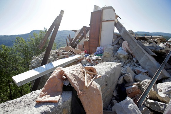 A coat is seen next to a collapsed house following an earthquake in Pescara del Tronto, central Italy, August 26, 2016. REUTERS/Max Rossi