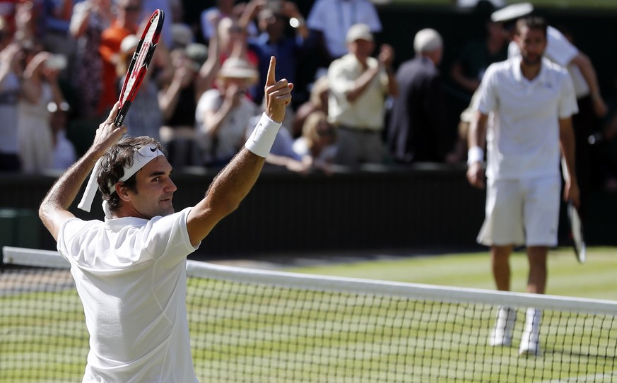 Roger Federer of Switzerland celebrates at match point after beating Marin Cilic of Croatia in their men&#039;s singles match on day ten of the Wimbledon Tennis Championships in London, Wednesday, Jul ...