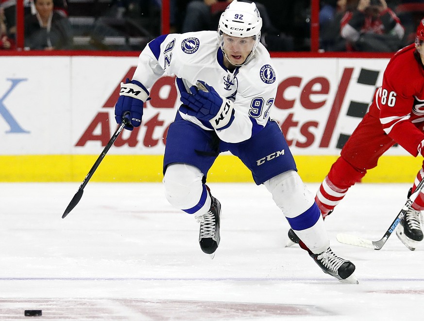 Tampa Bay Lightning&#039;s Joel Vermin (92) takes the puck down the ice after taking it away from Carolina Hurricanes&#039; Teuvo Teravainen (86) during the first period of an NHL hockey game, Sunday, ...