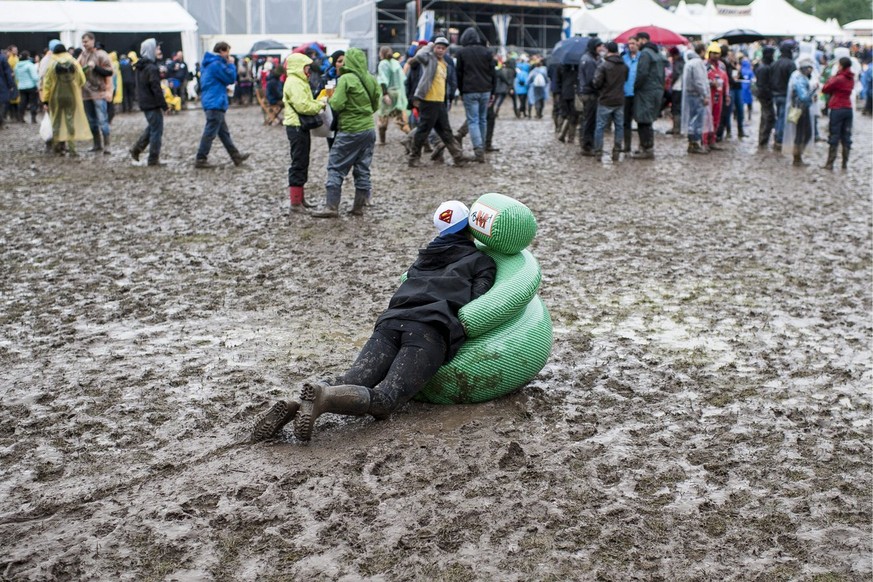 A visitor is playing in the mud at the OpenAir St. Gallen on Saturday, June 29, 2013, in St. Gallen. The OpenAir St.Gallen is one of the oldest outdoor festivals in Switzerland. It's close to the ...