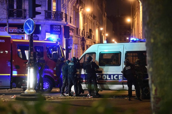 epa05023832 Police officers gather outside the Bataclan concert venue in Paris, France, 13 November 2015, where a gunman has reportedly taken people hostage. At least 26 people have died in attacks in ...