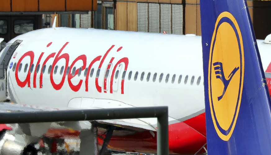 FILE - In the Sept. 21, 2017 file photo an Air Berlin plane sits behind a Lufthansa plane in Tegel airport in Berlin. (Wolfgang Kumm/dpa via AP)