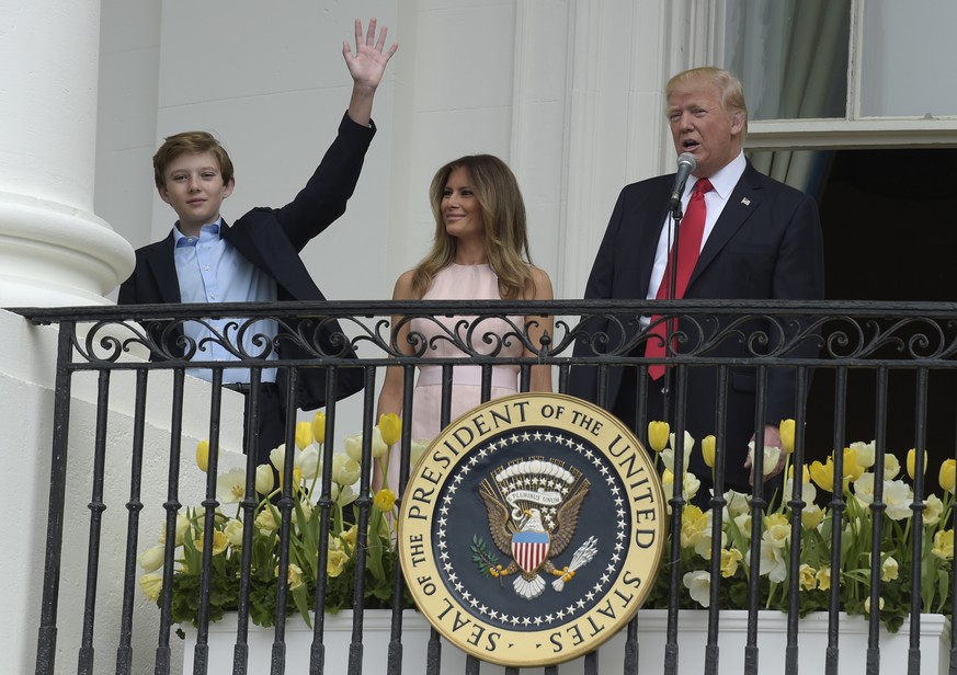President Donald Trump, accompanied by first Lady Melania Trump, introduces their son Barron Trump from the Truman Balcony of the White House in Washington, Monday, April 17, 2017, during the annual W ...