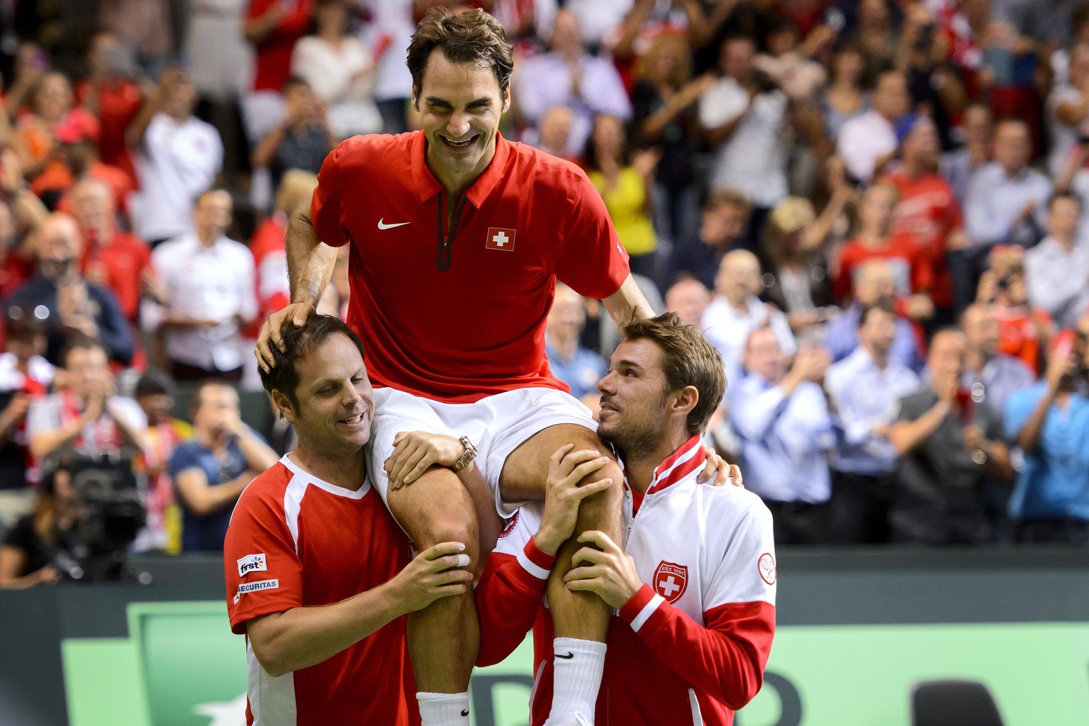 Severin Lüthi und Stan Wawrinka tragen Roger Federer durch die Palexpo-Halle.