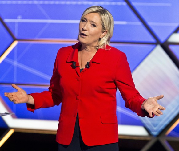 Far-right leader Marine le Pen gestures as she speaks during a TV-debate at French TV station TF1 in Saint Denis, outside Paris, Sunday, Sept. 11, 2016. Polls suggest far right leader Marine Le Pen is ...