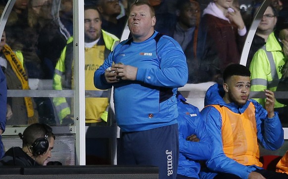 Britain Football Soccer - Sutton United v Arsenal - FA Cup Fifth Round - The Borough Sports Ground - 20/2/17 Sutton United&#039;s substitute Wayne Shaw eats a pie during the match Action Images via Re ...