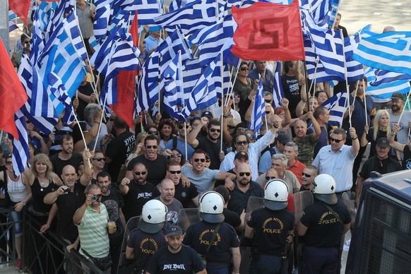 epa04297695 Supporters of far-right Golden Dawn Party shout slogans outside the appeals court in Athens, Greece, 04 July 2014. Golden Dawn (GD) leader Nikos Mihaloliakos and deputies Christos Pappas a ...