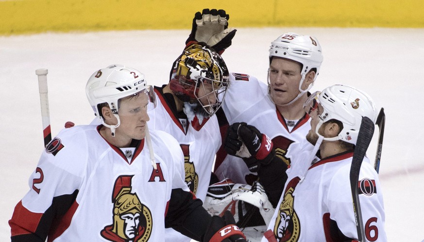 Ottawa Senators&#039; Dion Phaneuf (2), left to right, goalie Craig Anderson (41), Chris Neil (25) and Chris Wideman (6) celebrate their victory over the Vancouver Canucks following the third period o ...