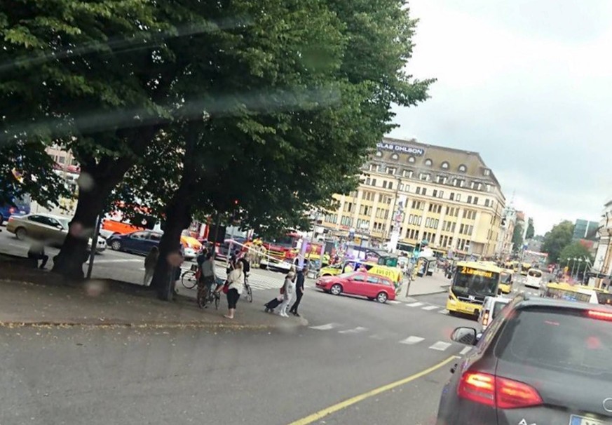 Turku Market Square on Friday, Aug. 18, 2017, with a yellow ambulance on the corner of the square (behind red car). Police in Finland say they have shot a man in the leg after he was suspected of stab ...