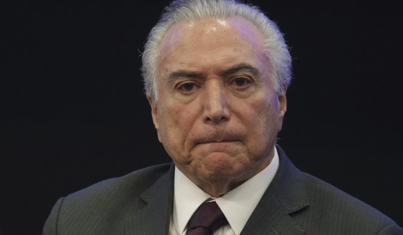 FILE - In this May 8, 2017, file photo, Brazil&#039;s President Michel Temer listens in during a event at the Brazilian Institute of Research in Brasilia, Brazil. Temer is denying a report that he end ...