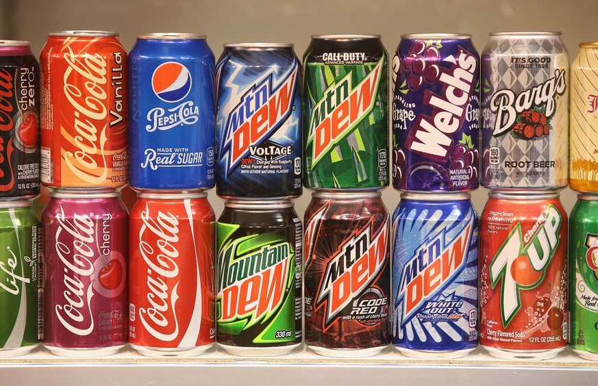 BERLIN, GERMANY - JANUARY 16: Sugary softdrinks from the USA, including Mountain Dew, Coca-Cola, 7Up and Pepsi, stand on display at a stand at the International Green Week agricultural trade fair (Int ...