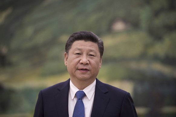 China's President Xi Jinping looks on before to meet with former US Secretary of State Henry Kissinger (not seen) at the Great Halll of the People in Beijing on December 2, 2016. (Nicolas Asfouri ...