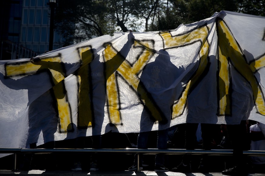 Israeli hardline nationalist supporters of Israeli army medic Sgt. Elor Azaria hold a banner with his name outside the Israeli military court in Tel Aviv, Israel, Wednesday, Jan. 4, 2017. Scuffles eru ...