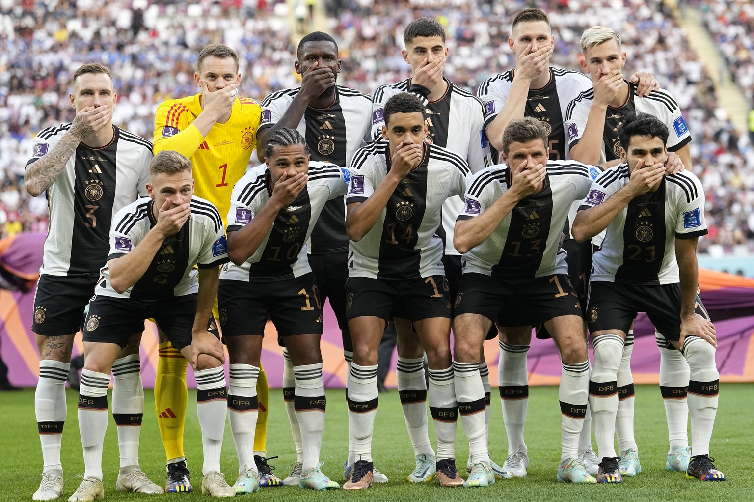 FILE - Players from Germany pose for the team photo as they cover their mouth during the World Cup group E soccer match between Germany and Japan, at the Khalifa International Stadium in Doha, Qatar,  ...
