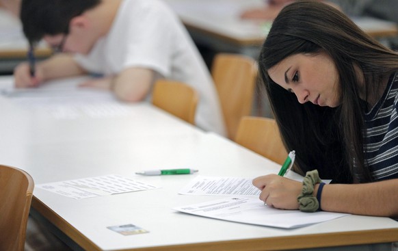 epa05349592 A student answers the questions of her exam on the first day of the University access exams in Valencia, eastern Spain, 07 June 2016. These three-day-long access exams, that have been goin ...