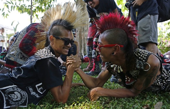 epa04701521 Two Myanmar punks during compete during an arm wrestling at a punk gathering ahead of the Thingyan water festival in Yangon, Myanmar, 12 April 2015. The annual water festival is celebrated ...