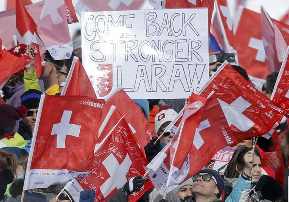 Alpine Skiing - FIS Alpine Skiing World Championships - Women&#039;s Downhill - St. Moritz, Switzerland - 12/2/17 - Fans of Switzerland&#039;s Lara Gut, who is currently injured, hold up a sign readin ...