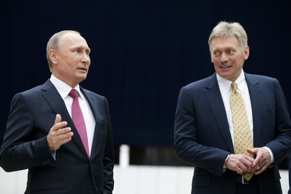 Russian President Vladimir Putin speaks to the media after his annual televised call-in show as his press secretary Dmitry Peskov, right, smiles in Moscow, Russia, Thursday, June 15, 2017. The 64-year ...