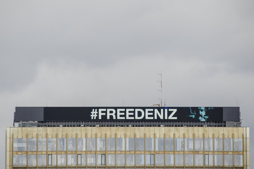 epa05820461 The hashtag &#039;#freedeniz&#039; is displayed on top of the Axel Springer building in Berlin, Germany, 28 February 2017. It referrs to the social media campaign to protest the arrest and ...