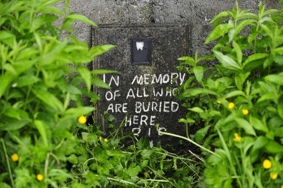 epa04242257 A handwritten note is painted on the site of a mass grave of up to 800 children on the site of the former Mother and Baby home in Tuam, County Galway, in western Ireland, 06 June 2014. The ...