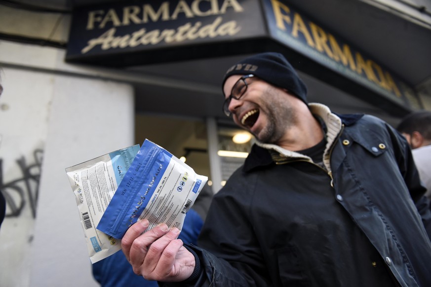 CORRECTS FIRST NAME - Diego Zas shows two bags of legal marijuana he just bought at the Antartida drugstore in downtown Montevideo, Uruguay, Wednesday, July 19, 2017. Marijuana is going on sale at 16  ...