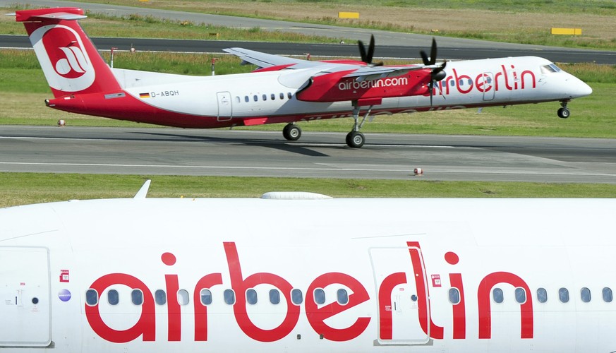 FILE - In this July 7, 2013 file photo planes of Air Berlin pictured at Tegel airport in Berlin. European Union anti-trust regulators have approved Germany&#039;s plan to provide troubled low-cost car ...